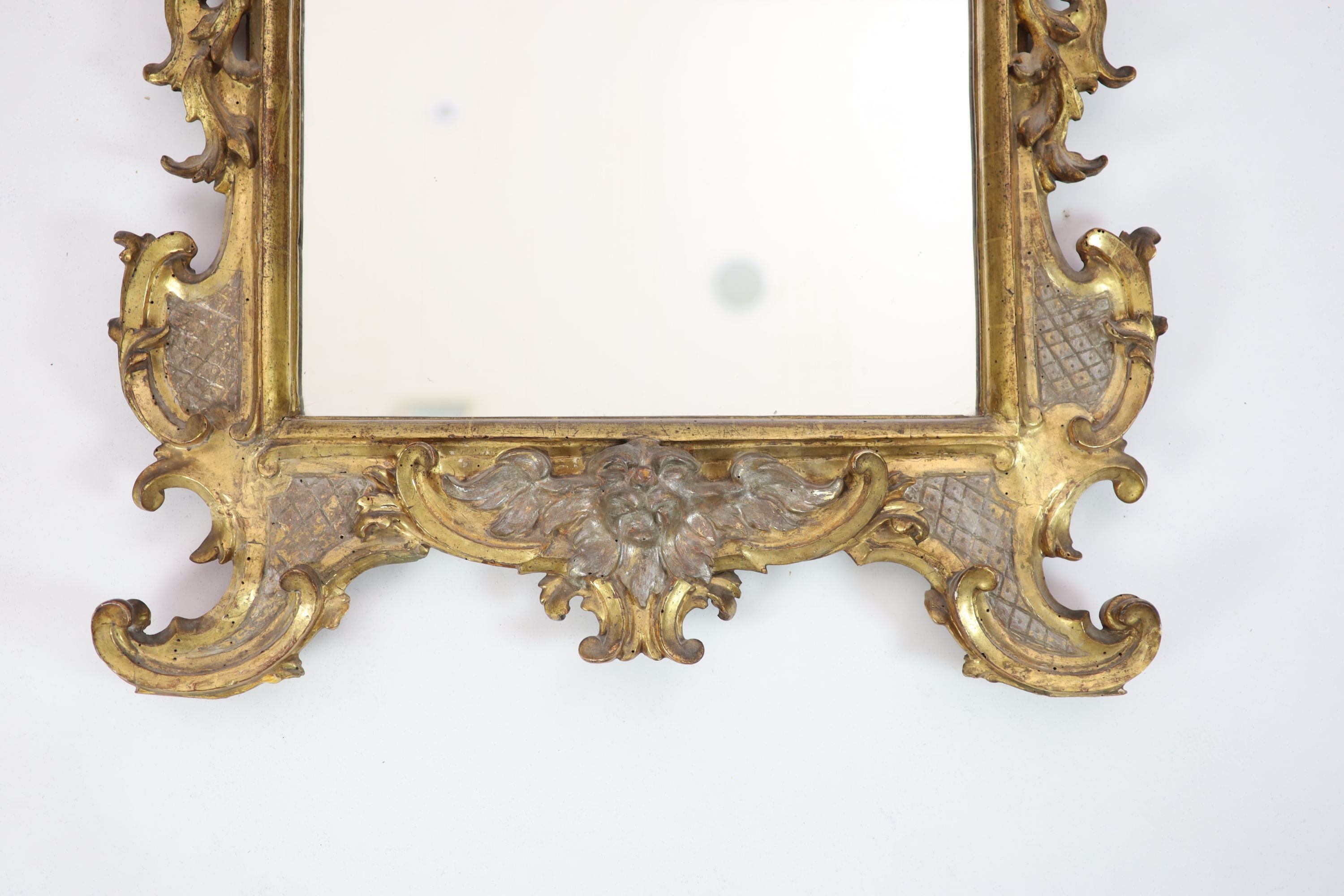 An 18th century Florentine giltwood wall mirror, W.78cm H.140cm